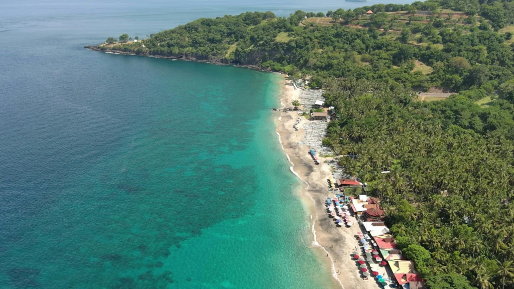 Tropical beach in Bali, Indonesia with turquoise waters and palm trees, ideal for summer vacations in Asia