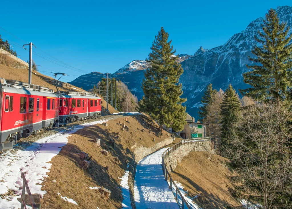 Best European train Glacier Express passing through Swiss Alps in winter